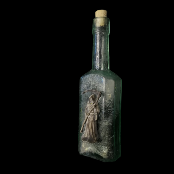 PLAGUE POWDER APOTHECARY BOTTLE: A very old remedy bottle, adorned with an abstract Grim Reaper, holds harmless black powder.